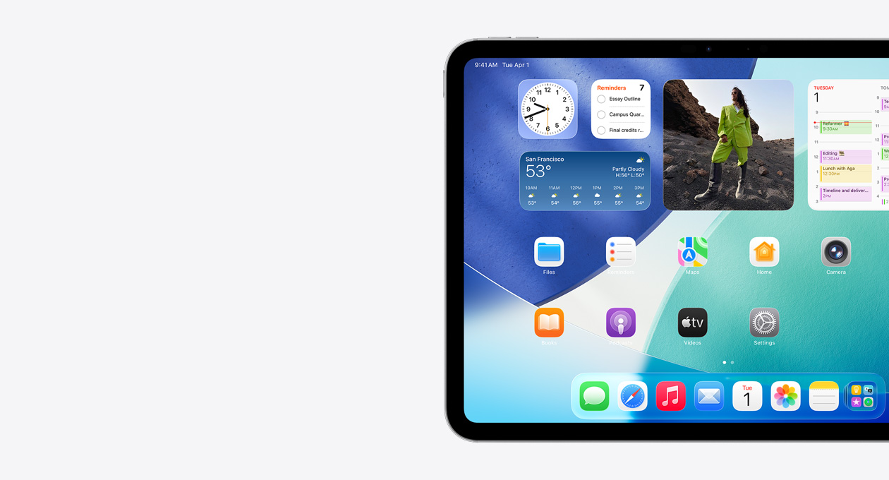 橫屏放置的 iPad，僅展示屏幕左側(cè)，主屏幕具有疊放的小組件，包括呈現(xiàn) Liquid Glass 效果的半透明時鐘、提醒事項 app、天氣小組件、兩排較小的 app 以及程序塢。
