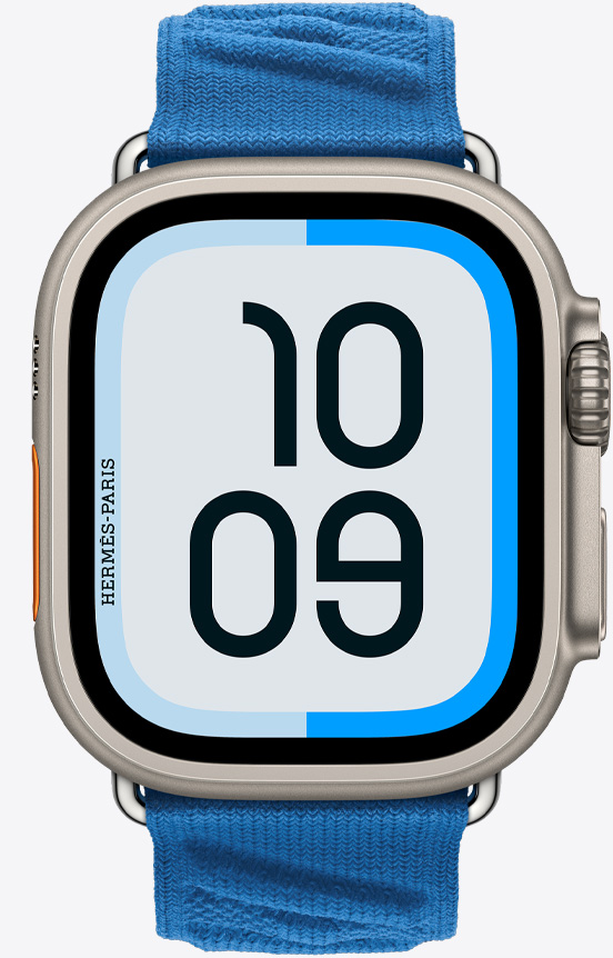 Apple Watch Hermès Ultra 2 的正面視圖，展示航海表盤和新款 Bleu Hydra 水妖藍(lán)色 (海藍(lán)色系) En Mer 表帶。