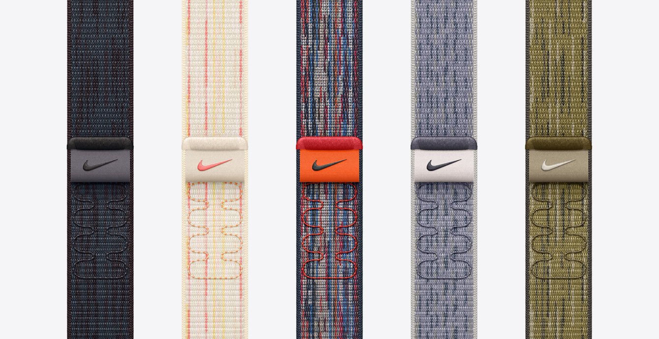 五條不同顏色的 Nike 回環(huán)式運動表帶，包括黑配藍色、星光色配粉色、藍配紅色、灰配藍色和綠配灰色。